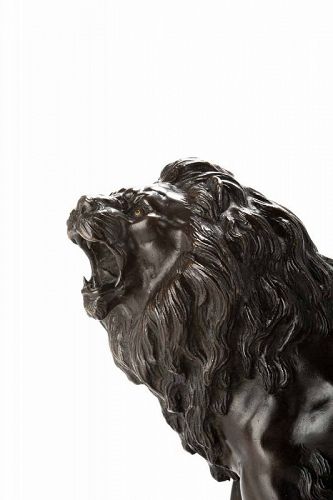 A Japanese bronze okimono depicting a roaring lion