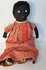 Old black cloth doll with red calico dress antique stockinette