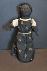A darling  10" stockinette doll with calico dress and astrakhan hair