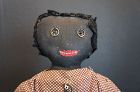 Very folky black doll with curtain ring eyes and a squared off head