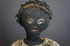 an unpretentious  black cloth doll with a great painted face 17" 1880
