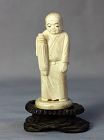 Japanese carved Bone Okimono, figure on wooden stand
