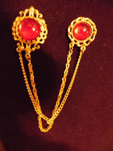 Gold tone sweater guard pins with ruby red cabochons