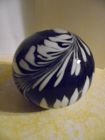 Black and white feather plume glass paperweight