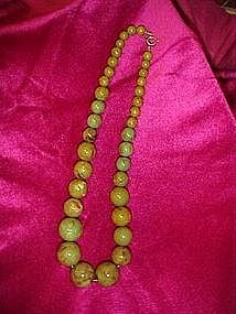 Green swirl bakelite necklace.