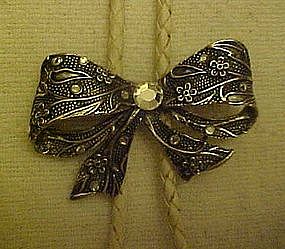 Silvertone bow with rhinestones, bolo tie