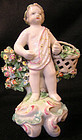 Derby Porcelain Figure of Putto carrying a basket